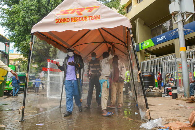 April 19, 2020, Nairobi, Kenya: Passengers pass through a sanitiser spray booth that disinfects the whole body at Kencom Bus Stop before boarding public transport to their various destinations as a preventive measure against the spread of Coronavirus..President Uhuru Kenyatta on March 25, 2020 imposed a dusk-to-dawn 21 day curfew from (7pm-5am) that took effect on Friday, March 26, 2020 in order to curb the spread of COVID-19. Kenya has so far recorded 270 cases of the Coronavirus, 67 recoveries and 14 deaths. Nairobi Kenya - ZUMAs197 20200419_zaa_s197_060 Copyright: xDennisxSigwex