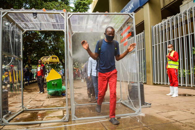 April 19, 2020, Nairobi, Kenya: Passengers pass through a sanitiser spray booth that disinfects the whole body at Kencom Bus Stop before boarding public transport to their various destinations as a preventive measure against the spread of Coronavirus..President Uhuru Kenyatta on March 25, 2020 imposed a dusk-to-dawn 21 day curfew from (7pm-5am) that took effect on Friday, March 26, 2020 in order to curb the spread of COVID-19. Kenya has so far recorded 270 cases of the Coronavirus, 67 recoveries and 14 deaths. Nairobi Kenya - ZUMAs197 20200419_zaa_s197_061 Copyright: xDennisxSigwex