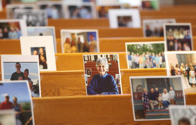 Photos of parishioners wait for the start of Rev. Bob Evans Sunday service at the Holy Spirit Catholic Church in Maryland Heights, Missouri on Sunday, April 19, 2020. Since members cannot attend in person because of the Coronavirus pandemic, Evans asked for his church to send in photos of themselves receiving over 500 photos from his 1500 membership. The photos are taped to the pews where the family sits, while he preforms the weekly service via Facebook live.  SLP2020041913 BILLxGREENBLATT