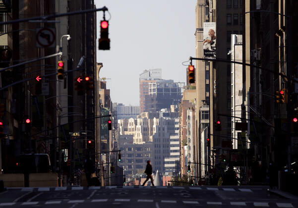 A woman wearing a protective face mask crosses 7th Avenue in a nearly empty of pedestrian and automobile traffic Times Square on Easter Sunday of Orthodox Easter weekend in New York City on Sunday, April 19, 2020. The world s Orthodox Christians are celebrating Easter through a series of restrictions and bans including closures of churches due to the Coronavirus pandemic. More than 13,300 people with COVID-19 have died in New York State.  NYP20200419130 JOHNxANGELILLO