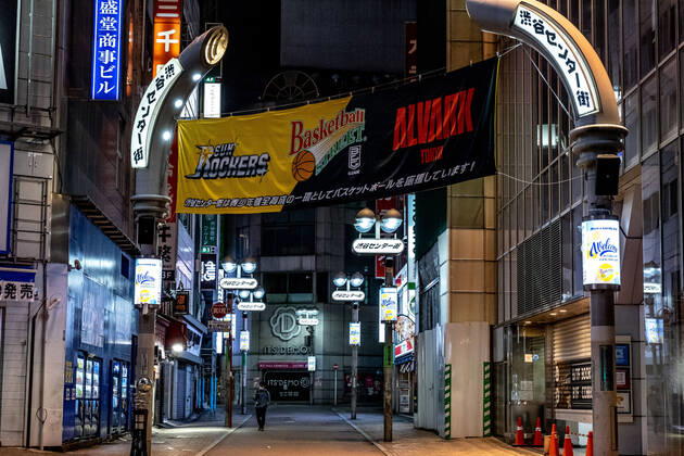 April 19, 2020, Tokyo, Japan: A man wearing a face mask for protection walks on along a deserted street in Shibuya area during the covid-19 crisis..The Japan government declared a state of emergency to cover the whole country and will continue until May 6. Tokyo governor, Yuriko Koike has asked restaurants and bars to be closed at 8pm as a preventive measure against COVID-2019. Tokyo Japan - ZUMAs197 20200419_zaa_s197_071 Copyright: xViolaxKamx