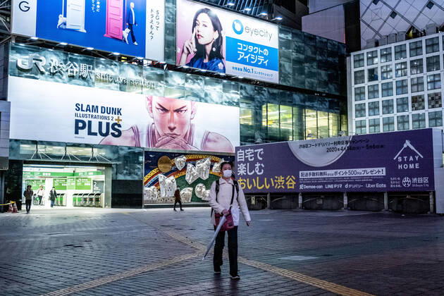 April 19, 2020, Tokyo, Japan: A woman wearing a face mask for protection walks on along a deserted street in Shibuya area during the covid-19 crisis..The Japan government declared a state of emergency to cover the whole country and will continue until May 6. Tokyo governor, Yuriko Koike has asked restaurants and bars to be closed at 8pm as a preventive measure against COVID-2019. Tokyo Japan - ZUMAs197 20200419_zaa_s197_073 Copyright: xViolaxKamx
