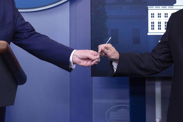April 19, 2020, Washington, District of Columbia, USA: United States President Donald J. Trump hands United States Vice President Mike Pence a swab during a news conference on the Coronavirus pandemic in the James S. Brady Press Briefing room at the White House in Washington D.C., U.S., on Sunday April 19, 2020. Speaker of the United States House of Representatives Nancy Pelosi (Democrat of California) stated that lawmakers are close to a deal with United States Secretary of the Treasury Steven T. Mnuchin regarding a second round of small business loans for businesses impacted by Coronavirus. Credit: CNP Washington USA - ZUMAs152 20200419_zaa_s152_027 Copyright: xStefanixReynoldsx