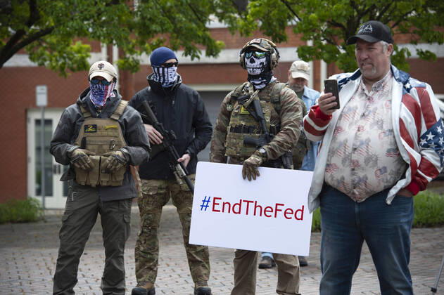 April 19, 2020, Canton, GA: A group of self-described conservative Ã patriots gather outside Cherokee County Courthouse on Sunday April 19 to protest the states Ã shelter in place orders because of the COVID19 pandemic.Several were armed with AR-15 weapons. Organizers voiced a list of grievances against the state, arguing citizens rights were being violated because of the orders, and vow to ignore state mandate. Canton - ZUMAn03_ 20200419_zaf_n03_015 Copyright: xRobinxRaynex