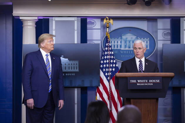 April 19, 2020, Washington, District of Columbia, USA: United States President Donald J. Trump, left, listens as United States Vice President Mike Pence delivers remarks on the Coronavirus pandemic during a news conference in the James S. Brady Press Briefing room at the White House in Washington D.C., U.S., on Sunday April 19, 2020. Speaker of the United States House of Representatives Nancy Pelosi (Democrat of California) stated that lawmakers are close to a deal with United States Secretary of the Treasury Steven T. Mnuchin regarding a second round of small business loans for businesses impacted by Coronavirus. Credit: CNP Washington USA - ZUMAs152 20200419_zaa_s152_035 Copyright: xStefanixReynoldsx