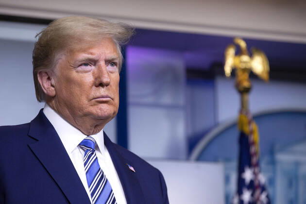 April 19, 2020, Washington, District of Columbia, USA: United States President Donald J. Trump listens as United States Vice President Mike Pence delivers remarks on the Coronavirus pandemic during a news conference in the James S. Brady Press Briefing room at the White House in Washington D.C., U.S., on Sunday April 19, 2020. Speaker of the United States House of Representatives Nancy Pelosi (Democrat of California) stated that lawmakers are close to a deal with United States Secretary of the Treasury Steven T. Mnuchin regarding a second round of small business loans for businesses impacted by Coronavirus. Credit: CNP Washington USA - ZUMAs152 20200419_zaa_s152_040 Copyright: xStefanixReynoldsx
