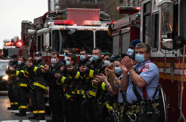 April 19, 2020, New York, New York, United States: New York firemen clap for health care workers fighting the coronovirus Sunday at 7pm, in front of the Langone Hospital, in what has become a nightly ritual all over the city, as the number of deaths from the coronavirus topped 13,000, even as the overall numbers of hospitalizations, intubations and deaths from Covid 19 continued to drop, suggesting the state could be turning a corner in its fight against the pandemic. New York United States - ZUMAl113 20200419_zap_l113_001 Copyright: xMiguelxJuarezxLugox