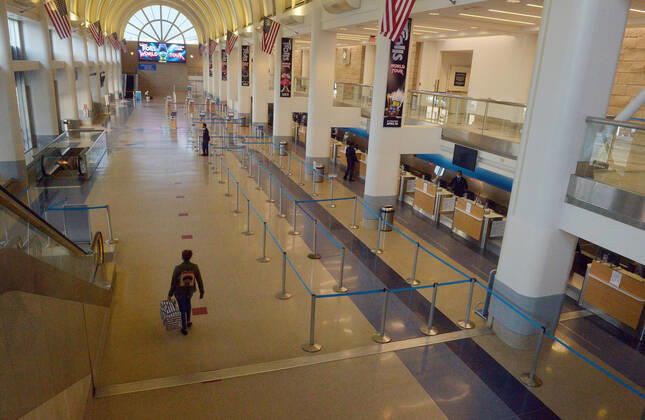 The American Airlines terminal is empty early evening at LAX on Sunday, April 19, 2020 in Los Angeles. Mayor Eric Garcetti said 95% of air travel has stopped in his city as Los Angeles sees the biggest drop of airplane travel in LAX history.  LAP2020041901 JIMxRUYMEN