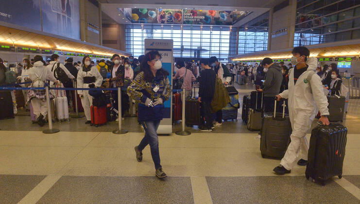 Hundreds of passengers form a line to check-in and board a China Southern Airlines midnight flight to China on Sunday, April 19, 2020 in Los Angeles. Passengers at the front of the line arrived at 5:30 a.m., with many others standing in line since 8 a.m. to ensure they would have a seat before the plane was full. Mayor Eric Garcetti said 95% of air travel has stopped in his city as Los Angeles sees the biggest drop of airplane travel in LAX history.  LAP2020041903 JIMxRUYMEN