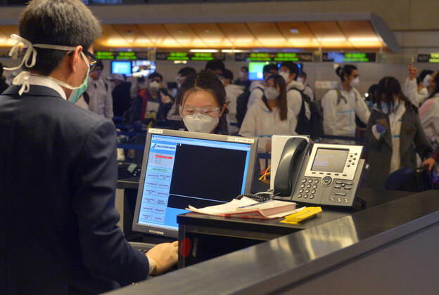 Hundreds of passengers form a line to check-in and board a China Southern Airlines midnight flight to China on Sunday, April 19, 2020 in Los Angeles. Passengers at the front of the line arrived at 5:30 a.m., with many others standing in line since 8 a.m. to ensure they would have a seat before the plane was full. Mayor Eric Garcetti said 95% of air travel has stopped in his city as Los Angeles sees the biggest drop of airplane travel in LAX history.  LAP2020041905 JIMxRUYMEN