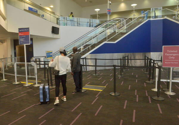 The Delta Air Lines terminal is empty early evening at LAX on Sunday, April 19, 2020 in Los Angeles. Mayor Eric Garcetti said 95% of air travel has stopped in his city as Los Angeles sees the biggest drop of airplane travel in LAX history.  LAP2020041926 JIMxRUYMEN