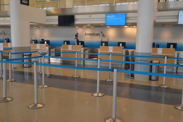 The American Airlines terminal is empty early evening at LAX on Sunday, April 19, 2020 in Los Angeles. Mayor Eric Garcetti said 95% of air travel has stopped in his city as Los Angeles sees the biggest drop of airplane travel in LAX history.  LAP2020041931 JIMxRUYMEN