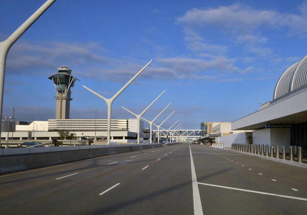 Los Angeles International Airport is devoid of activity early evening on Sunday, April 19, 2020 in Los Angeles. Mayor Eric Garcetti said 95% of air travel has stopped in his city as Los Angeles sees the biggest drop of airplane travel in LAX history.  LAP2020041936 JIMxRUYMEN