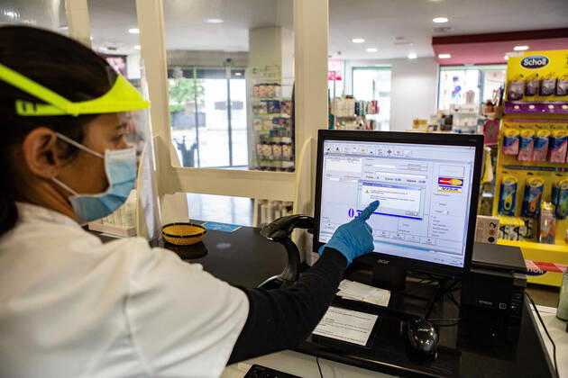 April 20, 2020, Girona, Spain: A pharmacist showing a system error on a computer screen during the Coronavirus (COVID-19) crisis..The Health Ministry has distributed facial masks to all pharmacies so that users can obtain them for free, they only deliver one mask per person on showing a medical card. Each user will receive one free facial mask per week. In the first hour, they started shipping, but the system collapsed due to high demand and currently it™s not possible to get face masks until the system is reset. Girona Spain - ZUMAs197 20200420_zaa_s197_017 Copyright: xMartixNavarrox