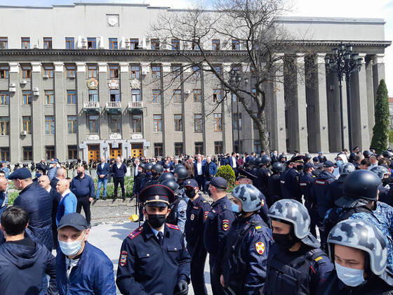 VLADIKAVKAZ, RUSSIA - APRIL 20, 2020: Law enforcement officers and people taking part in a protest against the self-isolation order in Svobody Square by the Palace of Justice. Non-working period was expanded in the Republic of North Ossetia till April 30, 2020 to prevent the spread of the novel coronavirus. Elina Sugarova TASS  TS0D6687