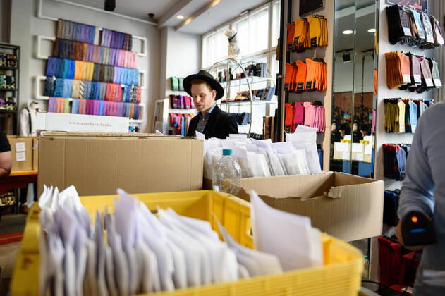 April 20, 2020: Boxes with goods in front of and company employees can be seen in the manufacture of the Luxury Tie Auerbach in the Hackesche HoÂ¶fe in Berlin Mitte. The company produces mouth-nose-masks made of noble fabrics, partly matching ties or bow ties. - ZUMAs172 20200420_zap_s172_037 Copyright: xJanxScheunertx