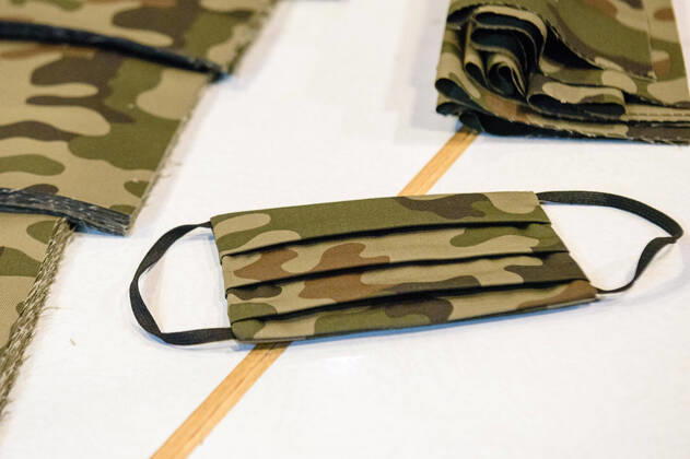 April 20, 2020: A protective mask with carmoflage pattern can be seen during the process of making a mask in the manufacture of the Luxury Tie Auerbach in the Hackesche HoÂ¶fe in Berlin Mitte. The company produces mouth-nose-masks made of noble fabrics, partly matching ties or bow ties. - ZUMAs172 20200420_zap_s172_040 Copyright: xJanxScheunertx