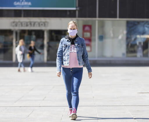 Deutschland, , , 20.04.2020, Presse, COVID-19 Deutschland faehrt langsam wieder hoch Bild: In Hessen haben die Geschaefte wieder geoeffnet, in Bayern nicht. Das wirkt sich vor allem auf die Osthessische Stadt Fulda aus, die nicht weit von der Bayerischen Landesgrenze entfernt liegt. Eine Frau läuft mit Mundschutz durch Fulda. Im Hintergrund ist die Karstadt Filliale, die allerdings noch geschlossen bleiben muss. Copyright: HMBxMedia OliverxMueller