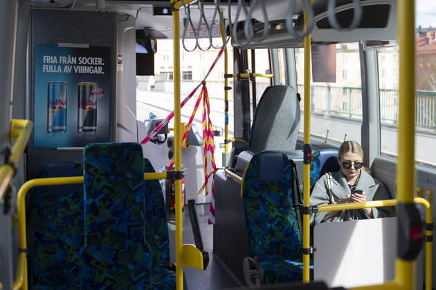 A woman uses her mobile phone on a local bus in Stockholm, Sweden, on April 20, 2020 The drivers area at the front door is cordoned off, and commuters have to enter the bus through the back doors to to protect bus drivers from the coronavirus Covid 19 STOCKHOLM SWEDEN x11950x,  Copyright: xAlixLorestani TTx SWEDEN DAILY LIFE CORONA