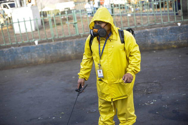 April 20, 2020, San Salvador, El Salvador: A municipal worker sanitizer the streets surrounding a market..A partial lockdown was placed in the cityÃ‚Â s downtown area. Soldiers and police officer have set dozens of control point to ensure people comply with the measures..El Salvador reports 218 cases and 7 deaths due to the novel Coronavirus. San Salvador El Salvador - ZUMAf143 20200420_zip_f143_003 Copyright: xCamiloxFreedmanx