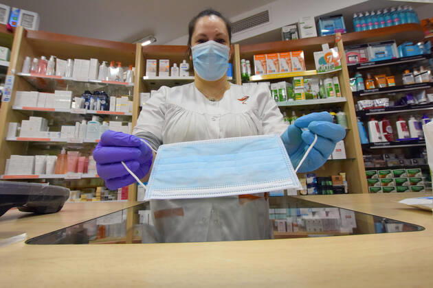 April 20, 2020, Vendrell, Spain: A pharmacist shows a free surgical mask provided by the Government of Catalonia to the citizens during the coronavirus pandemic..The pharmacies of Catalonia (Spain) today began to distribute surgical masks to prevent further contagion due to the Covid-19 health crisis that the Government of Catalonia sends to the population. Each citizen is assigned a free mask that is validated with their health cards and if they need a second one the citizen will have to pay for it. Vendrell Spain - ZUMAs197 20200420_zaa_s197_044 Copyright: xRamonxCostax