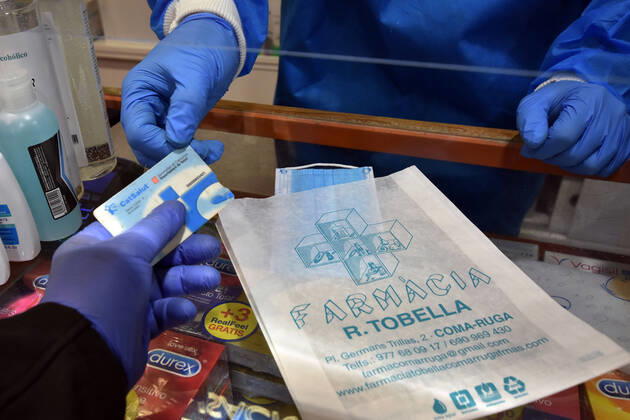 April 20, 2020, Vendrell, Spain: A man receives a free surgical mask with his Catalan health card in a pharmacy..The pharmacies of Catalonia (Spain) today began to distribute surgical masks to prevent further contagion due to the Covid-19 health crisis that the Government of Catalonia sends to the population. Each citizen is assigned a free mask that is validated with their health cards and if they need a second one the citizen will have to pay for it. Vendrell Spain - ZUMAs197 20200420_zaa_s197_047 Copyright: xRamonxCostax