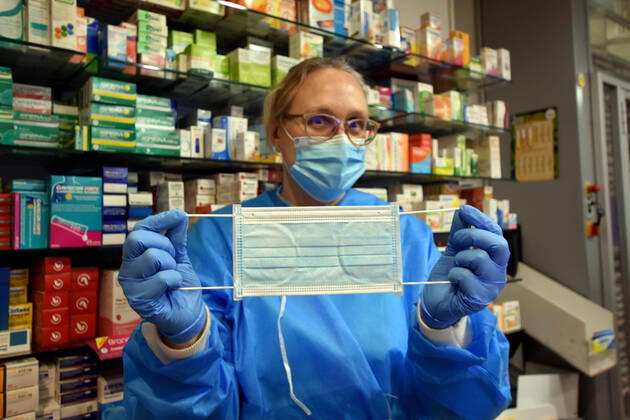 April 20, 2020, Vendrell, Spain: A pharmacist shows a free surgical mask provided by the Government of Catalonia to the citizens during the coronavirus pandemic..The pharmacies of Catalonia (Spain) today began to distribute surgical masks to prevent further contagion due to the Covid-19 health crisis that the Government of Catalonia sends to the population. Each citizen is assigned a free mask that is validated with their health cards and if they need a second one the citizen will have to pay for it. Vendrell Spain - ZUMAs197 20200420_zaa_s197_051 Copyright: xRamonxCostax