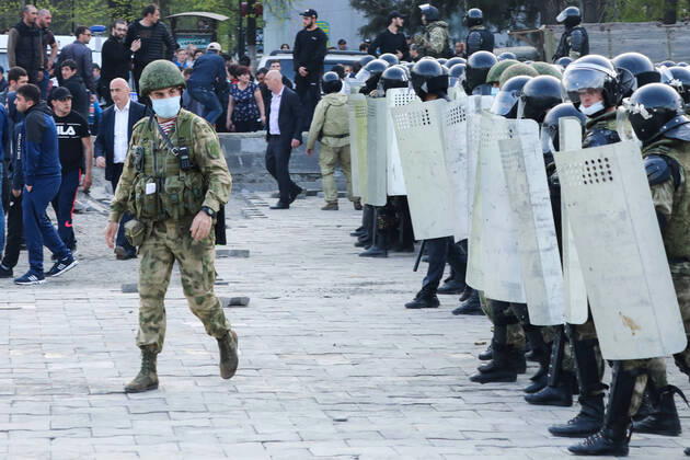 VLADIKAVKAZ, RUSSIA - APRIL 20, 2020: Riot police officers confront participants in a rally against the self-isolation order, in Svobody Square in front of the Palace of Justice. Non-working period was expanded in the Republic of North Ossetia till April 30, 2020 to prevent the spread of the novel coronavirus. Olga Smolskaya TASS  TS0D67A2