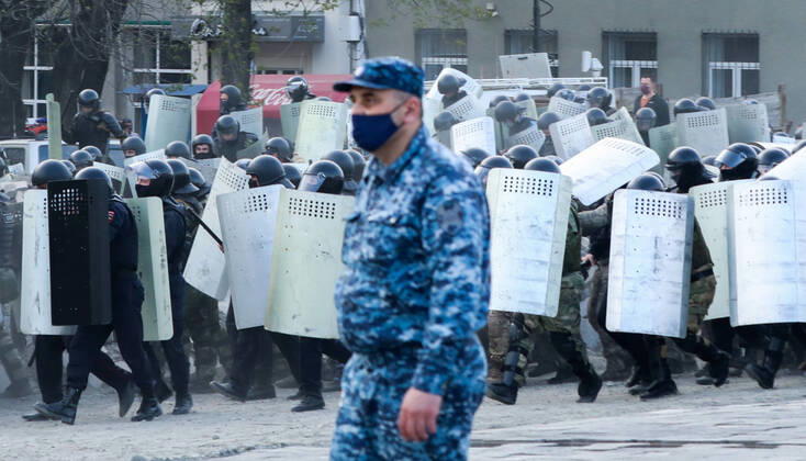 VLADIKAVKAZ, RUSSIA - APRIL 20, 2020: Riot police officers confront participants in a rally against the self-isolation order, in Svobody Square in front of the Palace of Justice. Non-working period was expanded in the Republic of North Ossetia till April 30, 2020 to prevent the spread of the novel coronavirus. Olga Smolskaya TASS  TS0D67A1