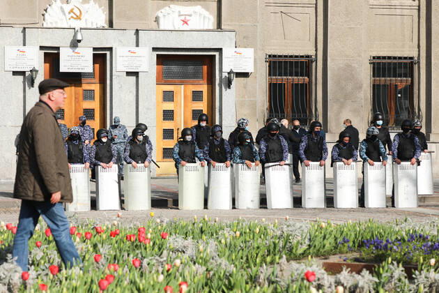 VLADIKAVKAZ, RUSSIA - APRIL 20, 2020: Riot police officer line up during a rally against the self-isolation order, in Svobody Square in front of the Palace of Justice. Non-working period was expanded in the Republic of North Ossetia till April 30, 2020 to prevent the spread of the novel coronavirus. Olga Smolskaya TASS  TS0D67A6