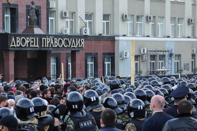 VLADIKAVKAZ, RUSSIA - APRIL 20, 2020: Riot police officer confront participants in a rally against the self-isolation order, in Svobody Square in front of the Palace of Justice. Non-working period was expanded in the Republic of North Ossetia till April 30, 2020 to prevent the spread of the novel coronavirus. Olga Smolskaya TASS  TS0D67A7