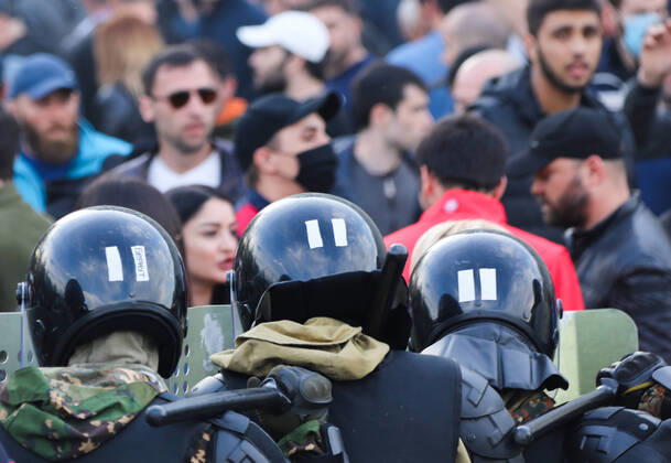 VLADIKAVKAZ, RUSSIA - APRIL 20, 2020: Riot police officer confront participants in a rally against the self-isolation order, in Svobody Square in front of the Palace of Justice. Non-working period was expanded in the Republic of North Ossetia till April 30, 2020 to prevent the spread of the novel coronavirus. Olga Smolskaya TASS  TS0D67A9
