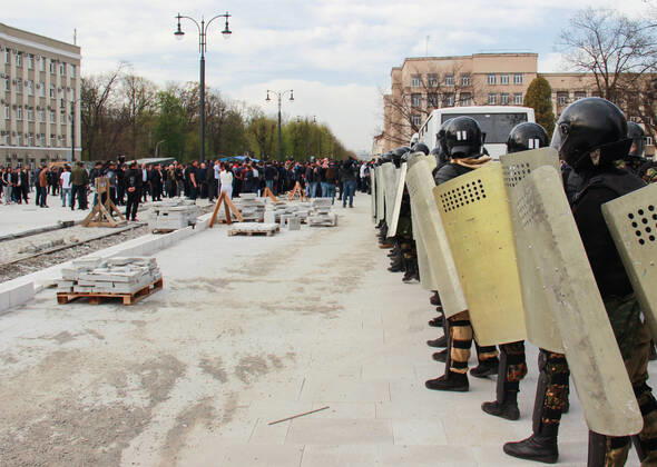 VLADIKAVKAZ, RUSSIA - APRIL 20, 2020: Riot police officers confront participants in a rally against the self-isolation order, in Svobody Square in front of the Palace of Justice. Non-working period was expanded in the Republic of North Ossetia till April 30, 2020 to prevent the spread of the novel coronavirus. Olga Smolskaya TASS  TS0D67BC