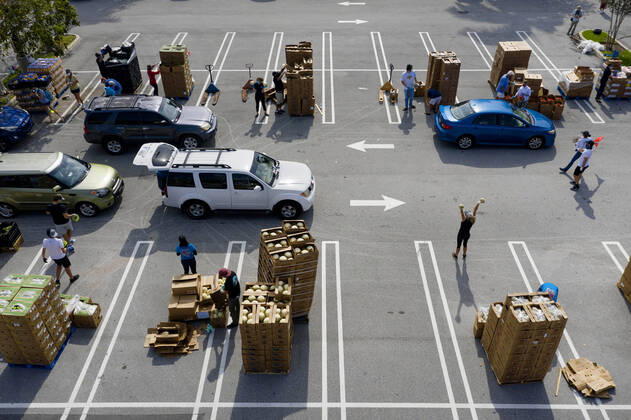 April 20, 2020, West Palm Beach, Florida, U.S: Cars line up at a drive-up food distribution center in the parking lot of the Palm Beach Outlets. People receive a one-week supply of a protein, fresh produce, eggs, milk, and other essential goods. The donations are limited to 800 cars on a first come first serve basis every Monday. Palm Beach Outlets partnered with Feeding South Florida to help those struggling during the coronavirus pandemic. West Palm Beach U.S - ZUMAl145 20200420_zap_l145_003 Copyright: xGreggxLovettx