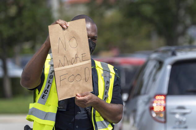 News Bilder des Tages April 20, 2020, West Palm Beach, Florida, U.S: Police officer J. Butler holds a sign alerting people that there is no more at a drive-up food distribution center in the parking lot of the Palm Beach Outlets. People receive a one-week supply of a protein, fresh produce, eggs, milk, and other essential goods. The donations are limited to 800 cars on a first come first serve basis every Monday. Palm Beach Outlets partnered with Feeding South Florida to help those struggling during the coronavirus pandemic. West Palm Beach U.S - ZUMAl145 20200420_zap_l145_004 Copyright: xGreggxLovettx