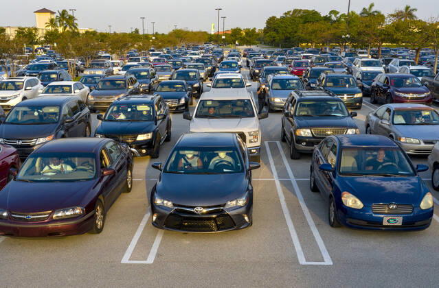 April 20, 2020, West Palm Beach, Florida, U.S: Cars line up at a drive-up food distribution center in the parking lot of the Palm Beach Outlets. People receive a one-week supply of a protein, fresh produce, eggs, milk, and other essential goods. The donations are limited to 800 cars on a first come first serve basis every Monday. Palm Beach Outlets partnered with Feeding South Florida to help those struggling during the coronavirus pandemic. West Palm Beach U.S - ZUMAl145 20200420_zap_l145_005 Copyright: xGreggxLovettx