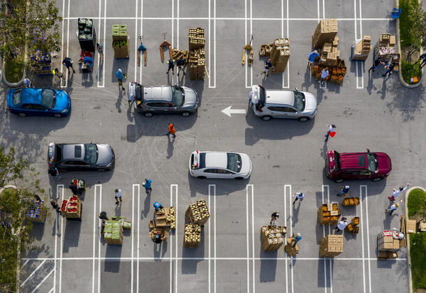 April 20, 2020, West Palm Beach, Florida, U.S: Cars line up at a drive-up food distribution center in the parking lot of the Palm Beach Outlets. People receive a one-week supply of a protein, fresh produce, eggs, milk, and other essential goods. The donations are limited to 800 cars on a first come first serve basis every Monday. Palm Beach Outlets partnered with Feeding South Florida to help those struggling during the coronavirus pandemic. West Palm Beach U.S - ZUMAl145 20200420_zap_l145_007 Copyright: xGreggxLovettx
