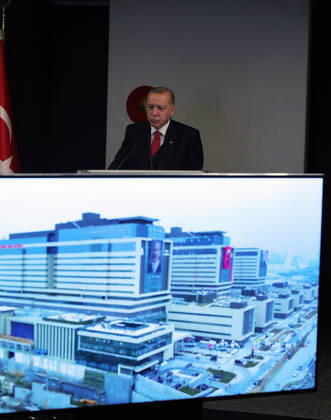 (200420) -- ISTANBUL, April 20, 2020 (Xinhua) -- Turkish President Recep Tayyip Erdogan attends the opening ceremony of the Basaksehir City Hospital via video conference in Istanbul, Turkey, on April 20, 2020. The first phase of a new mega-hospital, which will be used for treating COVID-19 patients, was inaugurated on Monday in Istanbul. The death toll of the virus in Turkey climbed to 2,017 and the confirmed cases totaled 86,306 on Sunday, according to the latest figures of the Health Ministry. (Xinhua) TURKEY-ISTANBUL-COVID-19-NEW MEGA-HOSPITAL