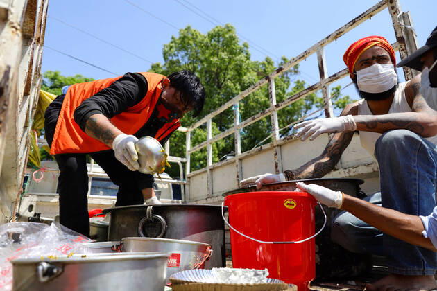 Nepal: Serving food to daily wager laborers The followers of Gorakhnath serve food to the daily wager laborers, during the nationwide lockdown imposed in the wake of Corona virus (COVID-19) Pandemic in Kathmandu, Nepal on April 20, 2020. Kathmandu Bagmati Nepal Copyright: SubashxShrestha