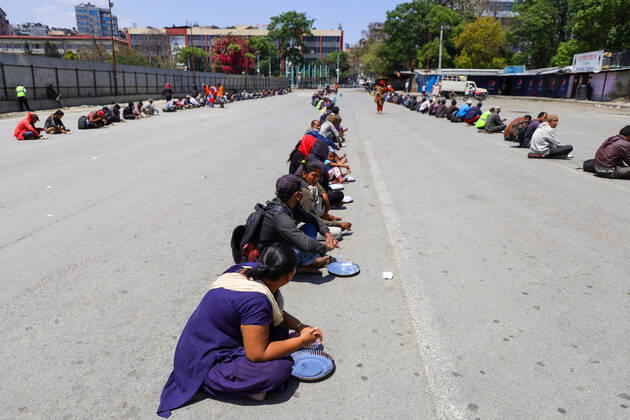 Nepal: Serving food to daily wager laborers Daily wager laborers waiting to receive food being distributed at Buspark, during the nationwide lockdown imposed in the wake of Corona virus (COVID-19) in Kathmandu, Nepal on April 20, 2020. Kathmandu Bagmati Nepal Copyright: SubashxShrestha