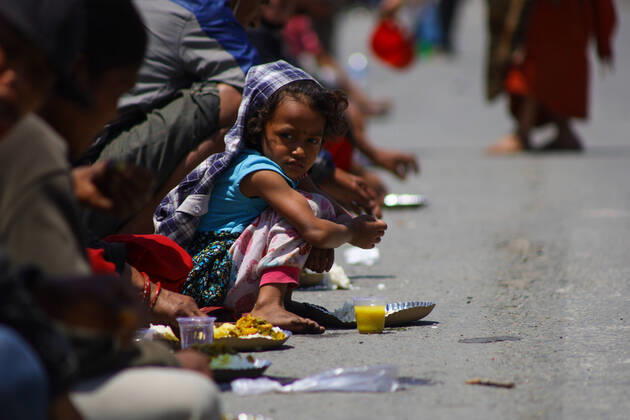 Nepal: Serving food to daily wager laborers A girl having food served by the follower of Gorakhnath during the nationwide lockdown imposed in the wake of Corona virus (COVID-19) pandemic in Kathmandu, Nepal on April 20, 2020. Kathmandu Bagmati Nepal Copyright: SubashxShrestha