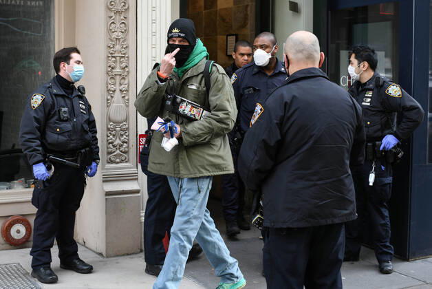 April 20, 2020, New York, New York, United States: As some red state governors consider relaxing social distancing policies, New York City police ticket a man who had allegedly taken part in an illegal gathering of more than two dozen people in ManhattanÃ¢â‚¬â ¢s Flatiron District Monday, potentially violating restrictions in place amid the Coronavirus epidemic. New York United States - ZUMAl113 20200420_zap_l113_004 Copyright: xMiguelxJuarezxLugox