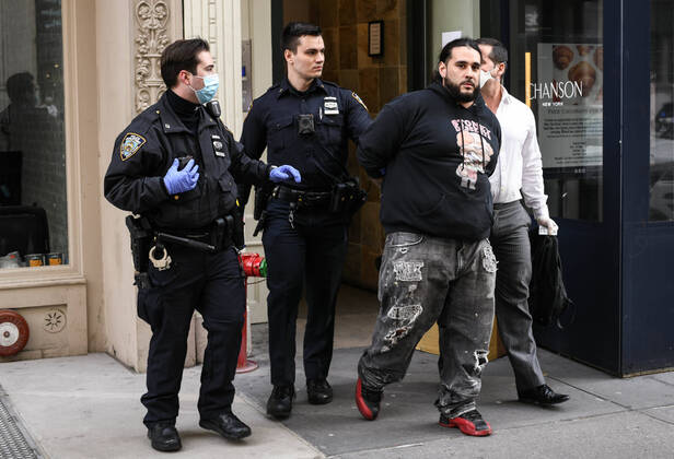 April 20, 2020, New York, New York, United States: As some red state governors consider relaxing social distancing policies, New York City police arrest a man who had allegedly taken part in an illegal gathering of more than two dozen people in ManhattanÃ¢â‚¬â ¢s Flatiron District Monday, potentially violating restrictions in place amid the Coronavirus epidemic. New York United States - ZUMAl113 20200420_zap_l113_006 Copyright: xMiguelxJuarezxLugox