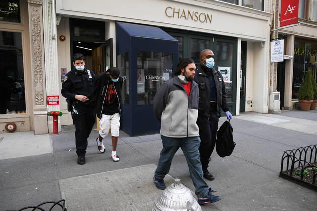 April 20, 2020, New York, New York, United States: As some red state governors consider relaxing social distancing policies, New York City police arrest two men who had allegedly taken part in an illegal gathering of more than two dozen people in ManhattanÃ¢â‚¬â ¢s Flatiron District Monday, potentially violating restrictions in place amid the Coronavirus epidemic. New York United States - ZUMAl113 20200420_zap_l113_007 Copyright: xMiguelxJuarezxLugox