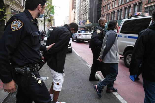 April 20, 2020, New York, New York, United States: As some red state governors consider relaxing social distancing policies, New York City police arrest two men who had allegedly taken part in an illegal gathering of more than two dozen people in ManhattanÃ¢â‚¬â ¢s Flatiron District Monday, potentially violating restrictions in place amid the Coronavirus epidemic. New York United States - ZUMAl113 20200420_zap_l113_008 Copyright: xMiguelxJuarezxLugox