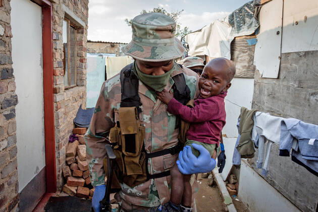 (200421) -- JOHANNESBURG, April 21, 2020 (Xinhua) -- A soldier of South African National Defense Force carries a baby in his arm in Johannesburg, South Africa, April 20, 2020. South Africa s COVID-19 cases have surged to 3,300, up by 142 from the previous count, Health Minister Zweli Mkhize said Monday. (Photo by Yeshiel Xinhua) SOUTH AFRICA-JOHANNESBURG-COVID-19 