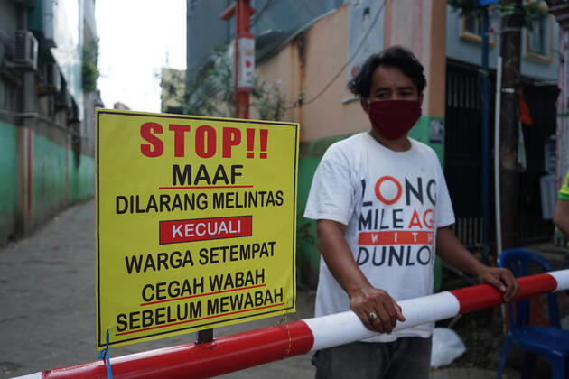 Indonesia: Lockdown to prevent from Covid-19 Residents in the settlements do a local lockdown of their area and forbid anyone who is not a local citizen to enter their area without any reason. In front of the gate, there is an iron bar and guarded by residents for 24 hours. Everyone who entered was checked for body temperature and anti-septic spray in an effort to prevent the spread of the Covid-19 outbreak in their area. Makassar South Sulawesi Indonesia Copyright: HerwinxBahar