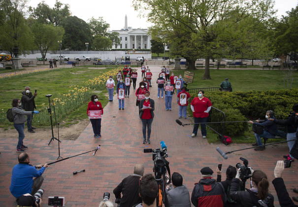 Registered Nurses hold photos of fellow nurses who have died from COVID-19 during a protest to calling attention on healthcare infections nationwide and demanding the Trump administration provide extra PPE for healthcare workers during the coronavirus pandemic, at the White House in Washington, D.C. on Tuesday, April 21, 2020.  WAP20200421304 KEVINxDIETSCH