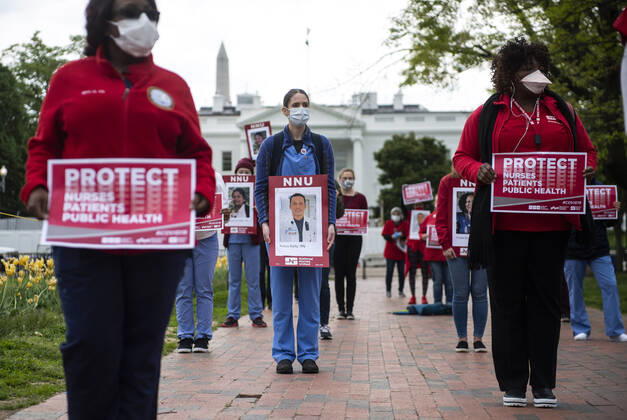 Registered Nurses hold photos of fellow nurses who have died from COVID-19 during a protest to calling attention on healthcare infections nationwide and demanding the Trump administration provide extra PPE for healthcare workers during the coronavirus pandemic, at the White House in Washington, D.C. on Tuesday, April 21, 2020.  WAP20200421306 KEVINxDIETSCH