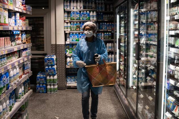 Paris, France, April 21, 2020 - Mrs. D., in her eighties, has just spent a dozen days in hospital after being infected with Coronavirus (Covid-19). Cured, she was able to return home, where Michele, a life assistant from the Neotine agency, goes several times a week to help her in her daily life - Michele does some grocery shopping at the  Copyright: xAlexisxSciardx